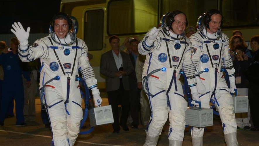 Les cosmonautes russes Oleg Kotov (c) et Sergueï Riazanski (d) et l'astronaute américain Michael Hopkins (g) le 25 septembre 2013 au cosmodrome de Baïkonour