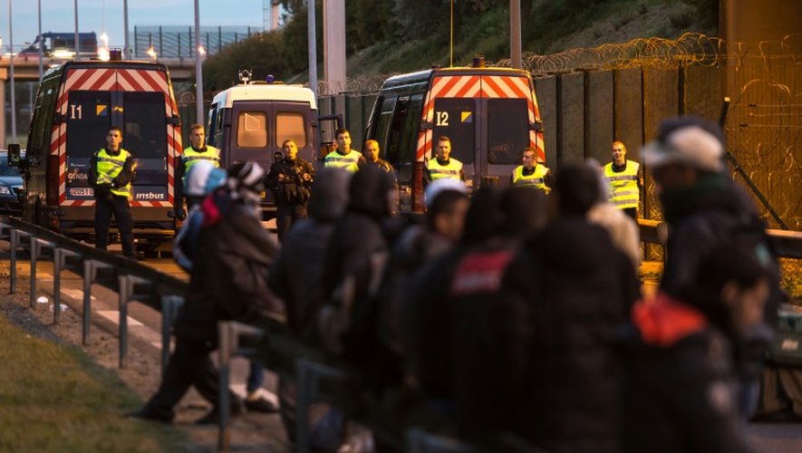 Des migrants bloqués par les gendrames à l'entrée de l'Eurotunnel le 30 juillet 2015 à Coquelles