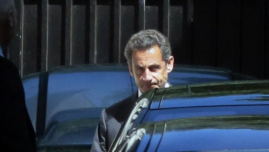 L'ancien président Nicolas Sarkozy, mis en examen dans la nuit pour corruption active, photographié à la sortie de son domicile le 2 juillet 2014 à Paris