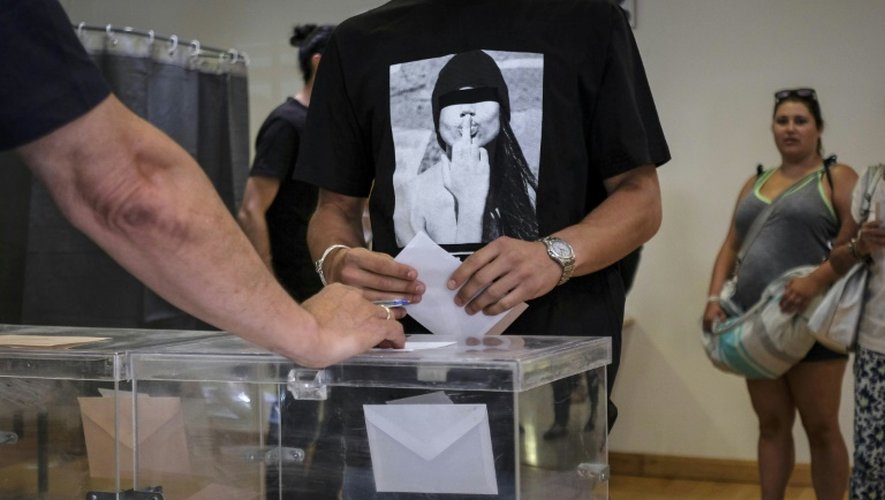 Un électeur dépose son bulletin dans l'urne dans un bureau de vote de Madrid, le 26 juin 2016