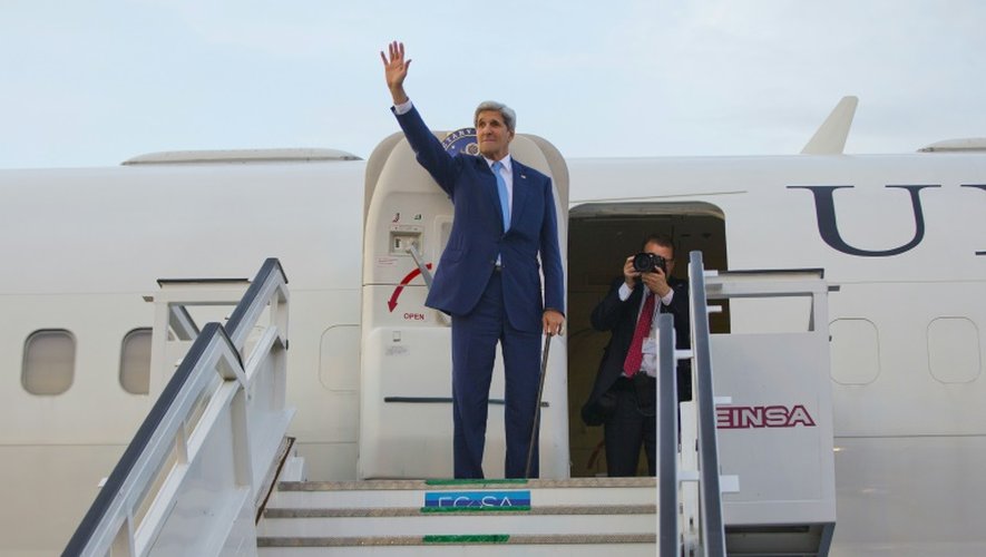 Le secrétaire d'Etat américain John Kerry salue depuis son avion avant de quitter l'aéroport de La Havane, le 14 août 2015