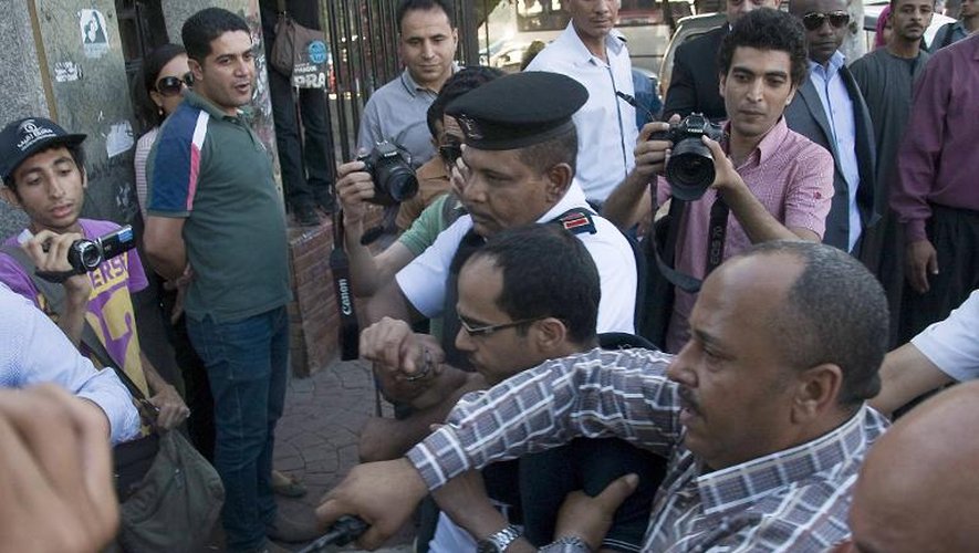 La police égyptienne arrête un homme soupçonné de harceler une femme dans une manifestation contre le harcèlement sexuel au Caire le 14 juin 2014