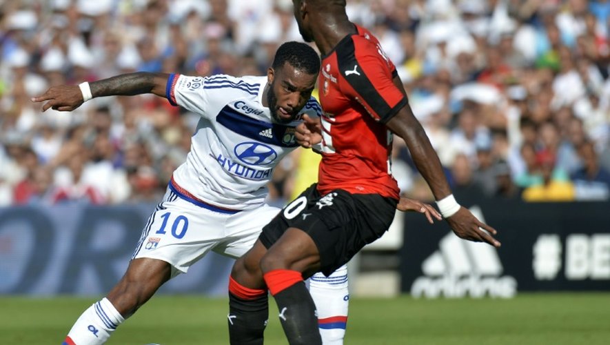 L'attaquant de Lyon Alexandre Lacazette (N.10) à la lutte avec le Rennais Yacouba Sylla, au stade de Gerland le 22 août 2015