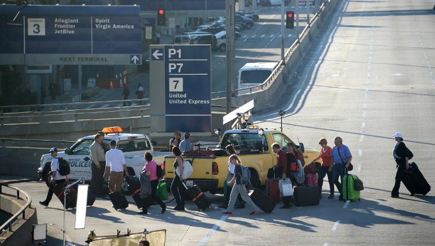 Des passagers quittent l'aéroport international de Los Angeles plusieurs heures après une fusillade, le 1er novembre 2013