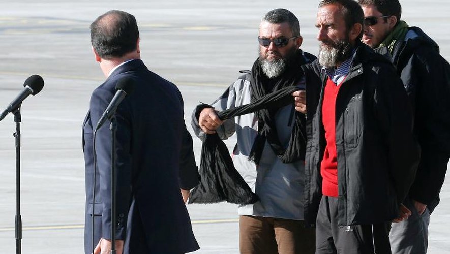 Les otages libérés, dont Daniel Larribe (en pullover rouge), avec le président de la République à l'aéroport de Villacoublay, le 30 octobre 2013
