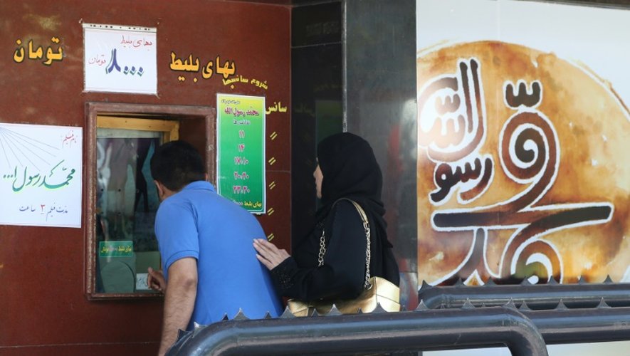 Des Iraniens achètent des places pour la première projection de "Mahomet", le film le plus cher de l'histoire du cinéma iranien consacré à l'enfance du prophète, le 27 août 2015 à Téhéran