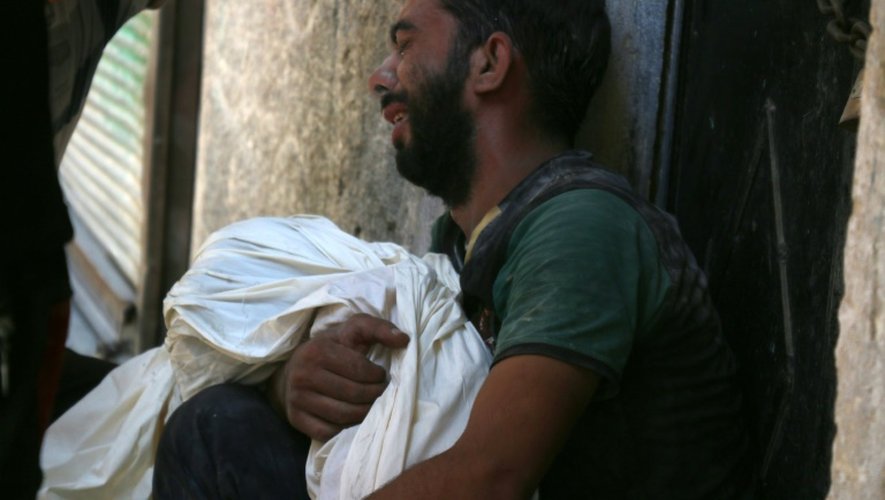 Un Syrien pleure la mort de son enfant dans le quartier de Saleheen, contrôlé par les rebelles, le 16 juillet 2016 dans le nord d'Alep