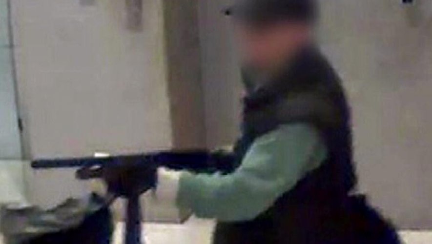 Photo fournie par BFM TV montrant un homme armé dans le hall du siège de la chaîne, le 15 novembre 2013