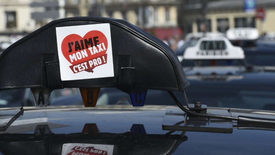 Un sticker a été apposé sur le signe lumineux d'un taxi, pendant une manifestation de chauffeurs de taxi anti-UberPOP, le 25 juin 2015 à Paris