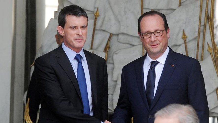 François Hollande et Manuel Valls à la sortie du dernier séminaire gouvernemental avant la pause estivale, le 1er août 2014 au Palais de l'Elysée