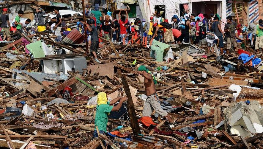 Des survivants du typhon Haiyan essayent de déblayer les décombres, le 27 novembre 2013 à Tacloban