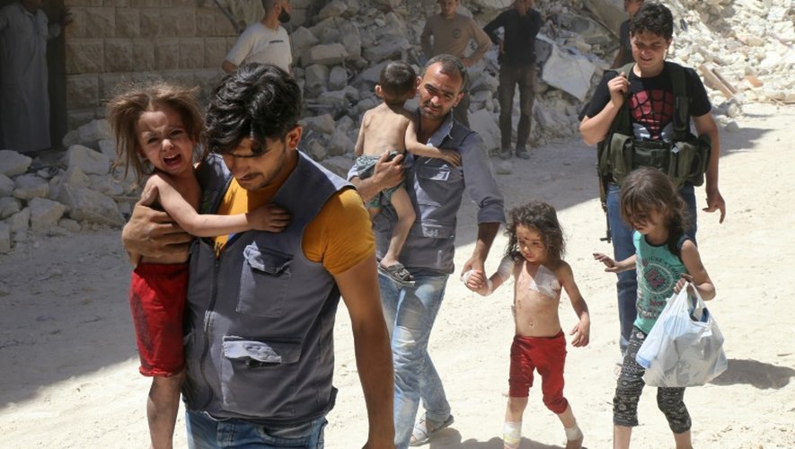 Des Syriens éloignent des enfants d'un quartier d'Alep (Syrie), tenu par des rebelles au régime d'Assad et qui a été la cible de bombardements aériens le 25 juillet 2016