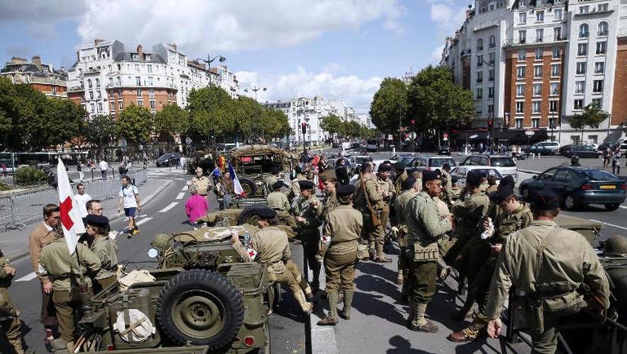 Des Parisiens portent les vêtements des soldats de la deuxième guerre mondiale à Paris le 23 août 2014 à l'occasion du 70e anniversaire de la Libération de Paris