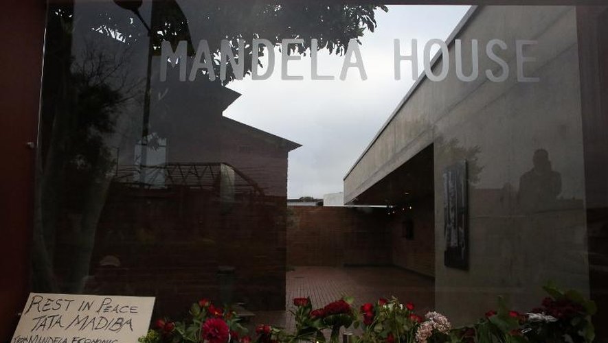 Des fleurs et des bougies à la mémoire de Nelson Mandela devant son ancienne maison à Soweto, le 6 décembre 2013
