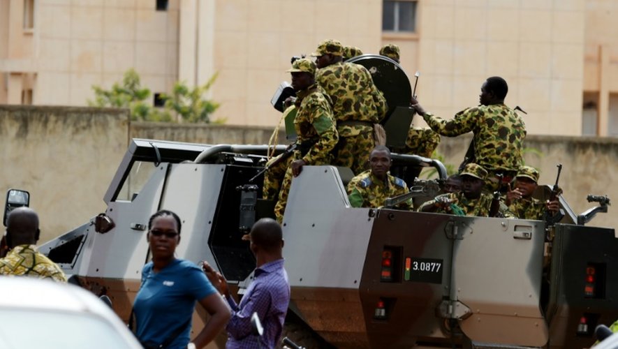 Des soldats dispersent des militants du mouvement Balai Citoyen lors d'une manifestation devant l'Hotel Liaco à Ouagadougou le 20 septembre 2015