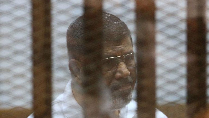 Le président islamiste Mohamed Morsi  destitué par l'armée, derrière les grillages du banc des accusés lors de son procès au Caire le 18 août 2014