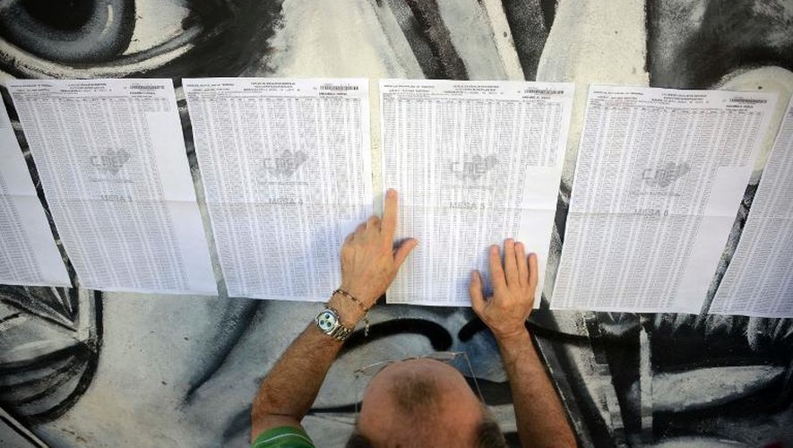 Un Vénézuélien cherche son nom sur les listes électorales pour les municipales dans un bureau de vote de Caracas, le 8 décembre 2013