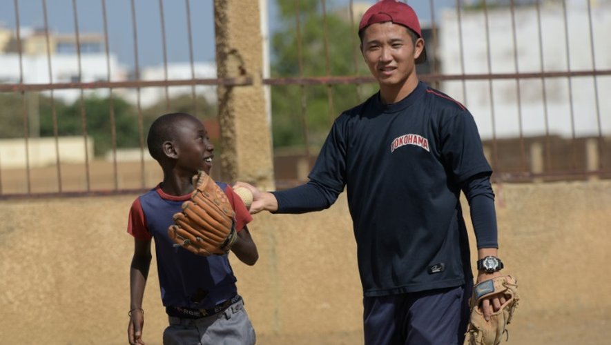 Ryoma Ogawa, volontaire japonais, conduit un entraînement de base-ball avec des enfants de Ouakam, un quartier du nord de Dakar, le 13 juillet 2016