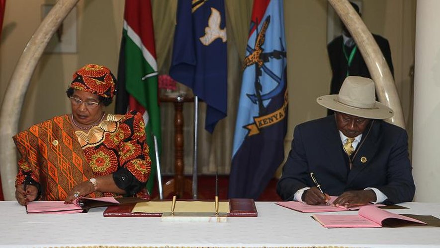 Le président de la Communauté de développement d'Afrique australe (g) et la présidente du Malawi, Joyce Banda, signent le 12 décembre 2013 un accord de paix entre les rebelles du M23 et le gouvernement de RDC à Nairobi