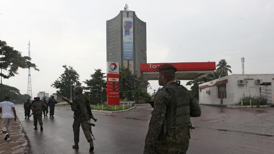Des soldats de l'armée régulière congolaise patrouillent le 30 décembre 2013 alors que des attaques ont eu lieu au siège de la télévision nationale, à l'aéroport international et sur la base de l'état-major à Kinshasa