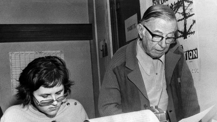 L'écrivain et philosophe Jean-Paul Sartre (d),  aux côtés d'une journaliste le 5 mars 1973, dans une salle de rédaction du quotidien Libération dont le premier numéro allait être lancé le 18 avril 1973
