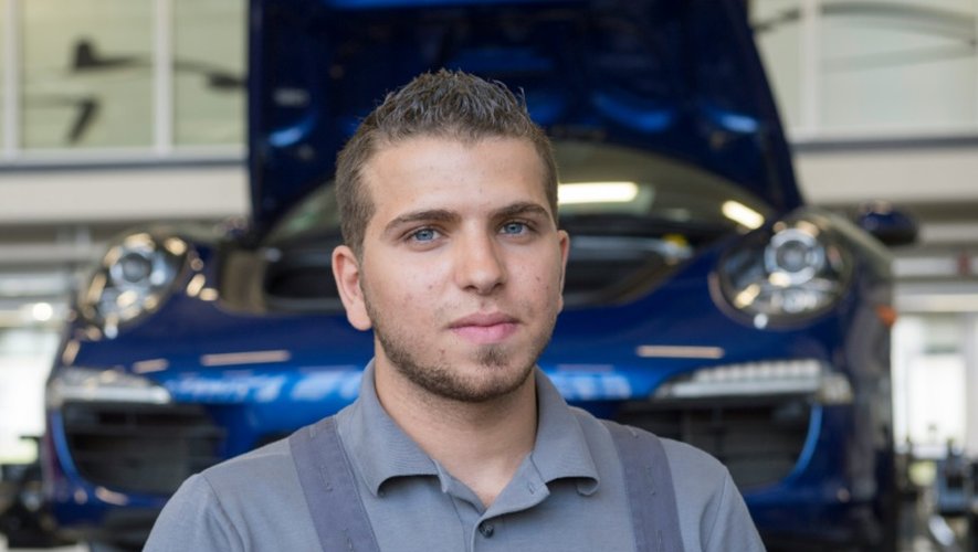 Ammar Alkhouli, 19 ans réfugié de Syrie, pose au centre de formation de Porsche, à Stuttgart le 27 juillet 2016 où il apprend la mécanique dans le cadre d'un stage d'intégration