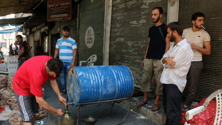 Un Syrien vend de l'essence dans un quartier d'Alep tenu par les rebelles, le 12 août 2016