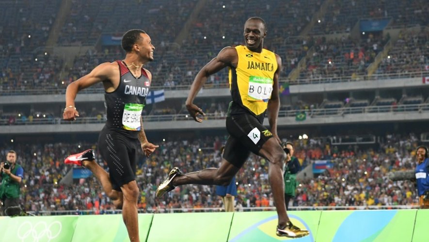 Le Jamaïcain Usain Bolt (d) termine en tête, devant le Canadien Andre De Grasse, sa demi-finale du 200 m aux JO de Rio, le 17 août 2016