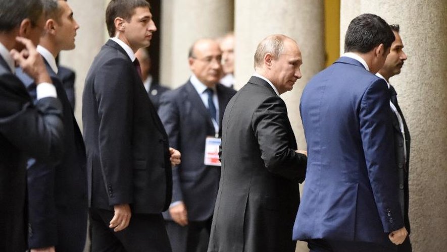 Le président Vladimir Poutine (g) accueilli par le Premier ministre italien Matteo Renzi (d) avant une rencontre avec le président ukrainien Petro Porochenko, en marge du sommet Europe-Asie, le 17 octobre 2014 à Milan