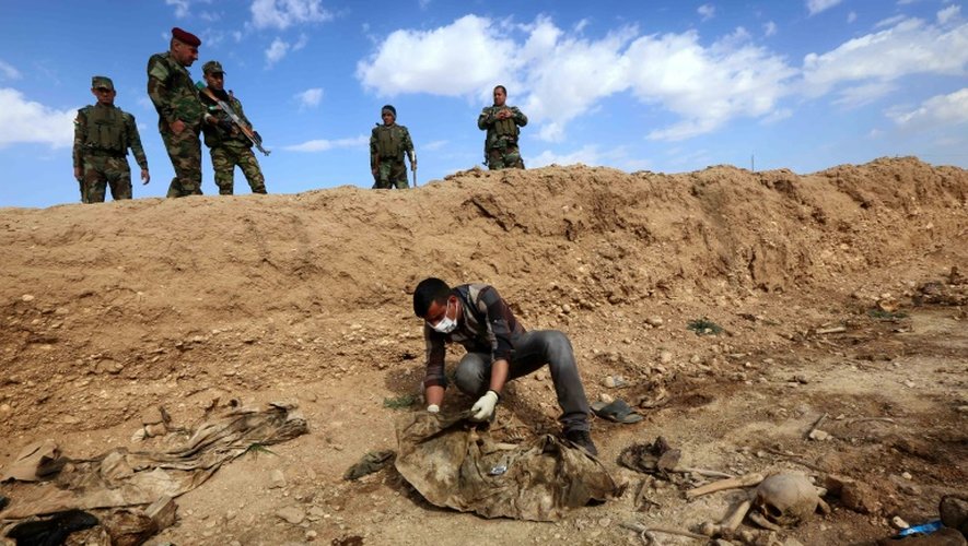 Un Iraquien inspecte les restes des corps de Yazidis tués par l'EI le 3 février 2015 au nord-ouest de l'Irak