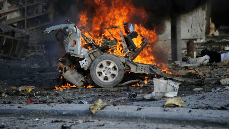 Un véhicule en feu le 1er novembre 2015 devant l'hôtel Sahafi à Mogadiscio après une attaque qui a fait au moins 12 morts