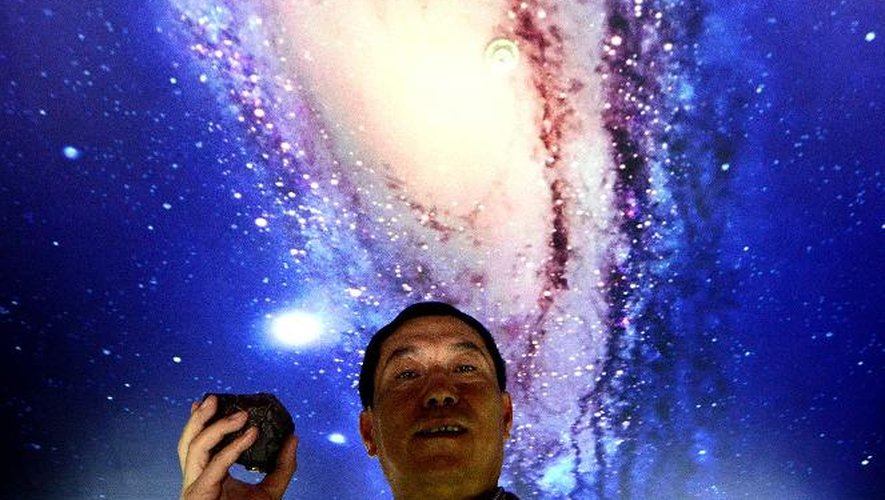 Tong Xianping montre une météorite le 19 septembre 2014 dans son espace d'exposition à Urumqi, capitale de la vaste région désertique du Xinjiang, dans l'ouest de la Chine