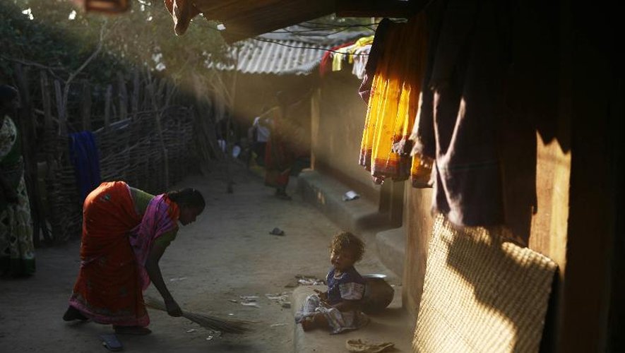 Une femme passe le balai devant son domicile dans l'Etat de Chhattisgarh, dans le centre de l'Inde