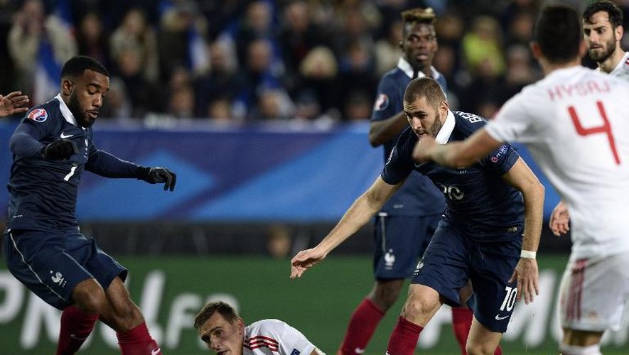 Les attaquants français Alexandre Lacazette (g) et Karim Benzema (d) tentent de reprendre la balle lors du match amical contre l'Albanie, le 14 novembre 2014 à Rennes