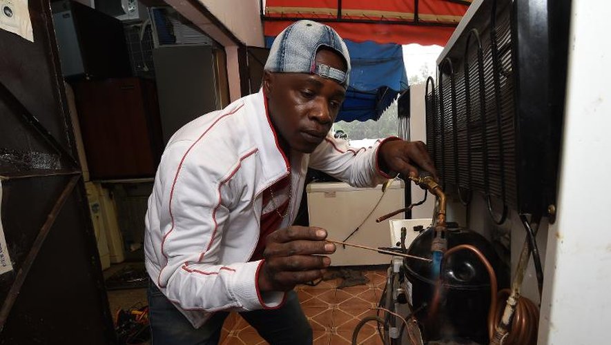 Moctar Touré, réfugié ivoirien, dans sa petite boutique spécialisée dans la réparation de matériel ménager, le 8 novembre 2014 à Rabat, au Maroc