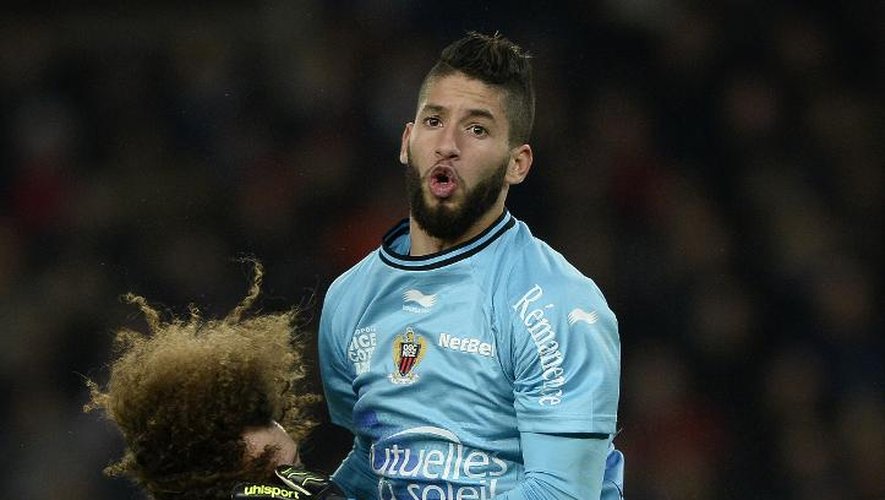 Le gardien niçois Mouez Hassen s'interpose devant le défenseur du Paris SG David Luiz (g), le 29 novembre 2014 au Parc des Princes
