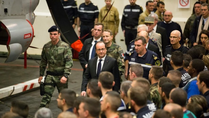 Le président François Hollande passe en revue le 4 décembre 2015 les troupes à bord du porte-avions Charles-de-Gaulle
