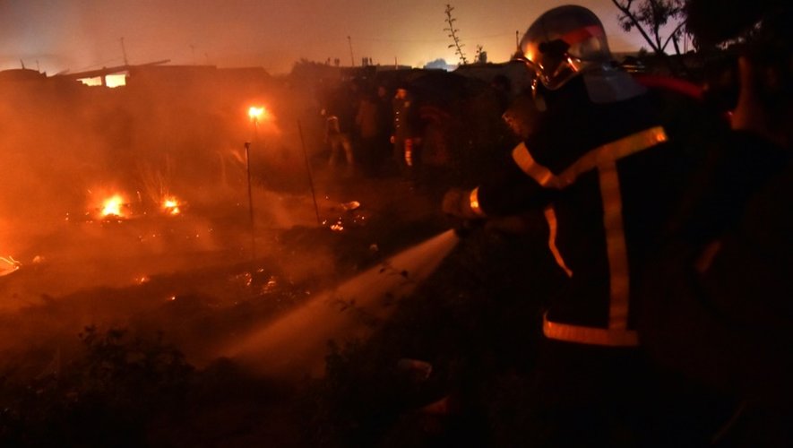 Des pompiers combattent les incendies allumés  dans la nuit du 25 au 26 octobre 2016 dans la "Jungle" à Calais