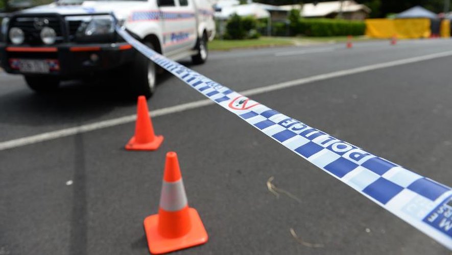 Un cordon de police empêche l'accès à la propriété où huit enfants ont été retrouvés morts et une femme blessée à Cairns, dans le nord-est de l'Australie, le 20 décembre 2014