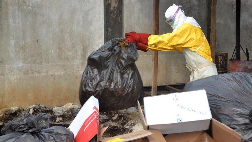 Un travailleur médical traite des déchets des malades du virus Ebola, le 8 décembre 2014 à Conakry, en Guinée, l'un des pays les plus touchés par l'épidémie
