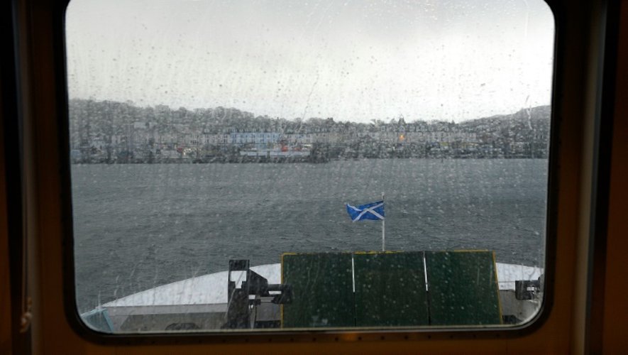 Le drapeau écossais flotte à la proue d'un ferry arrivant à Rothesay, sur l'île de Bute, en Ecosse, le 11 décembre 2015
