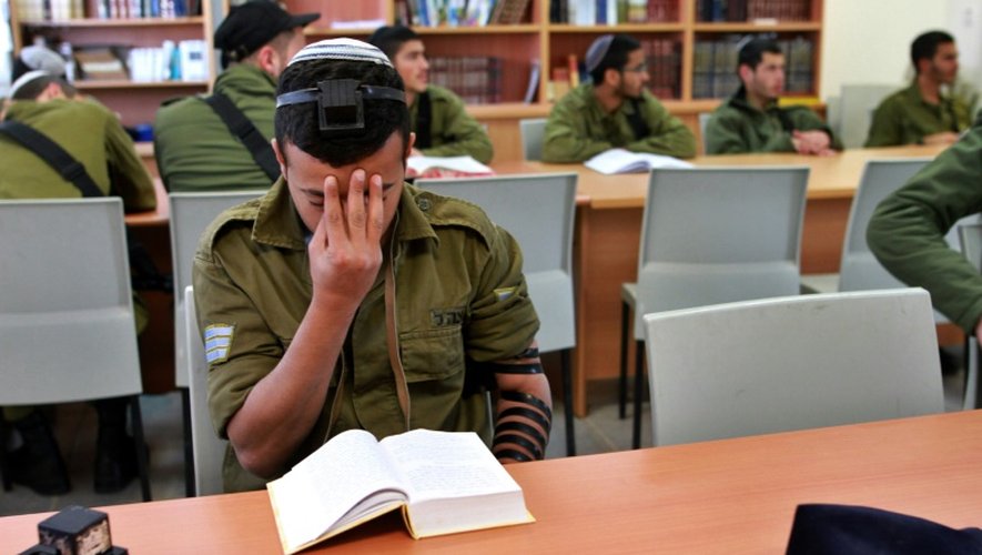 Un soldat juif pratiquant prie dans une synagogue installée dans une base militaire dans le désert du Néguev le 21 décembre 2015