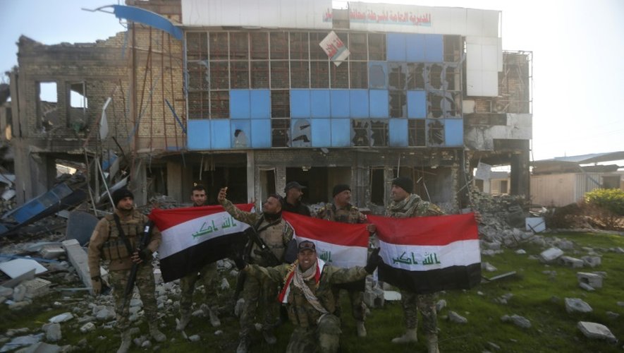 Le drapeau national brandi par les forces irakiennes le 28 décembre 2015 devant le siège de la police à Ramadi
