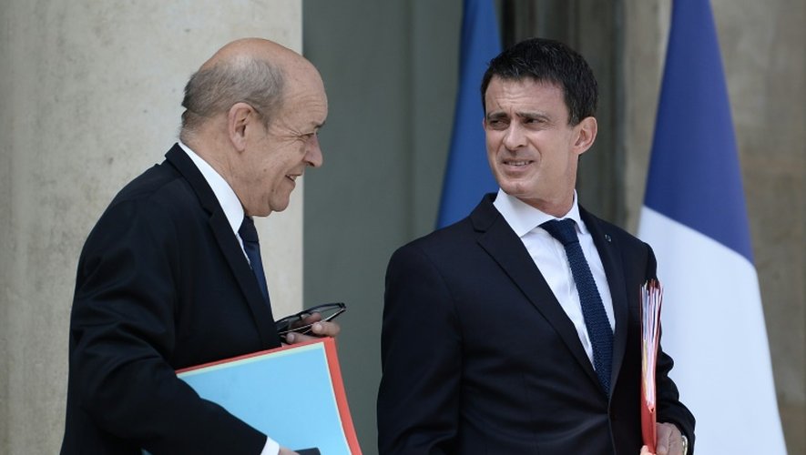 Le ministre de la Défense Jean-Yves Le Drian (G) s'entretient avec le Premier ministre Manuel Valls, le 22 juillet 2016 à Paris
