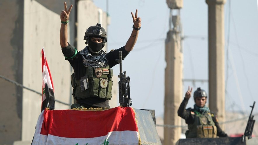 Un membre d'une troupe d'élite de contre-terrorisme lève les mains en signe de victoire le 29 décembre 2015 à Ramadi en Irak