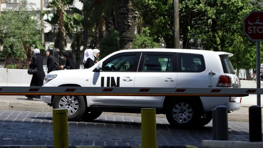 Des enquêteurs de l'ONU, chargés de déterminer la responsabilité d'attaques à l'arme chimique en Syrie, arrivent à Damas, le 18 août 2013