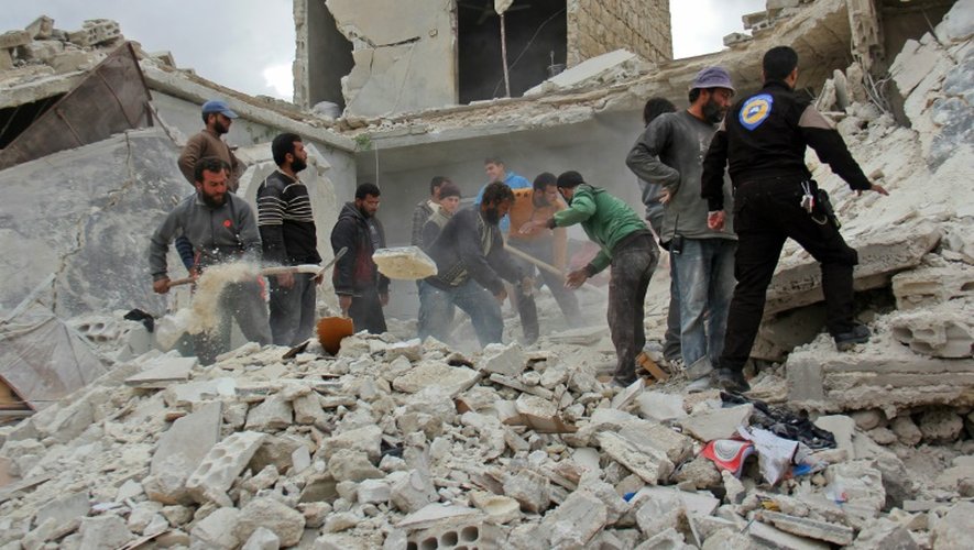 Des habitants recherchent des victimes dans les décombres des immeubles après une frappe aérienne du régime de Damas, le 16 novembre 2016 à Idleb, en Syrie