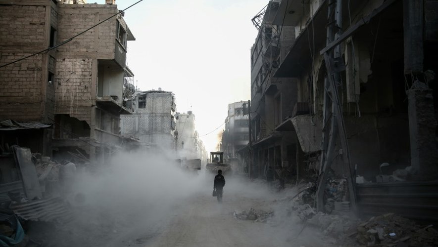 Un enfant marche à travers les décombres d'une rue de Douma, près de Damas, le 22 novembre