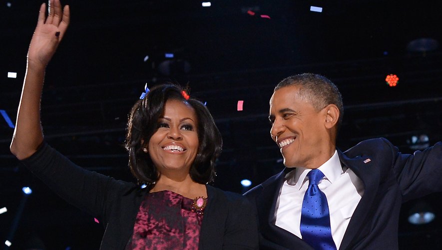 US President Barack Obama celebrates on stage with his wife Michelle after delivering his victory speech ion Chicago on November 7, 2012.