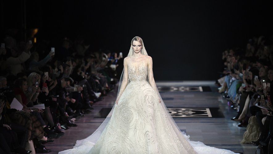 La robe de mariée de Georges Hobeika en tulle de soie beige brodée de cristaux, avec un voile brodée de cristaux et de paillettes. Collection haute couture SS19. Paris, le 21 janvier 2019.